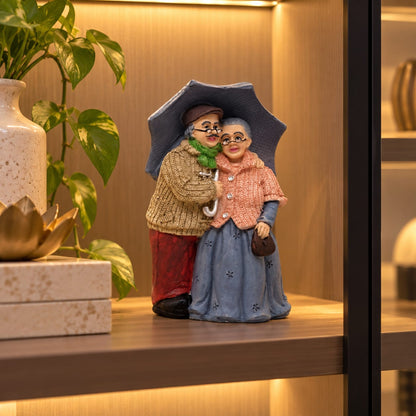Elderly Couple with Umbrella Figurine