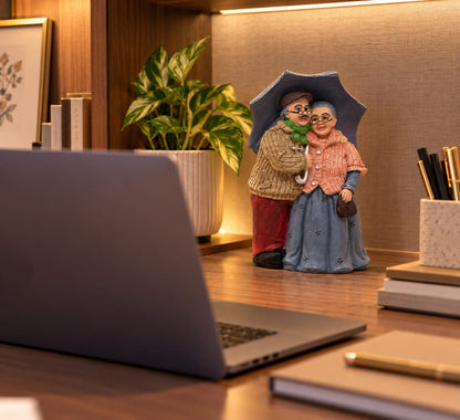 Elderly Couple with Umbrella Figurine